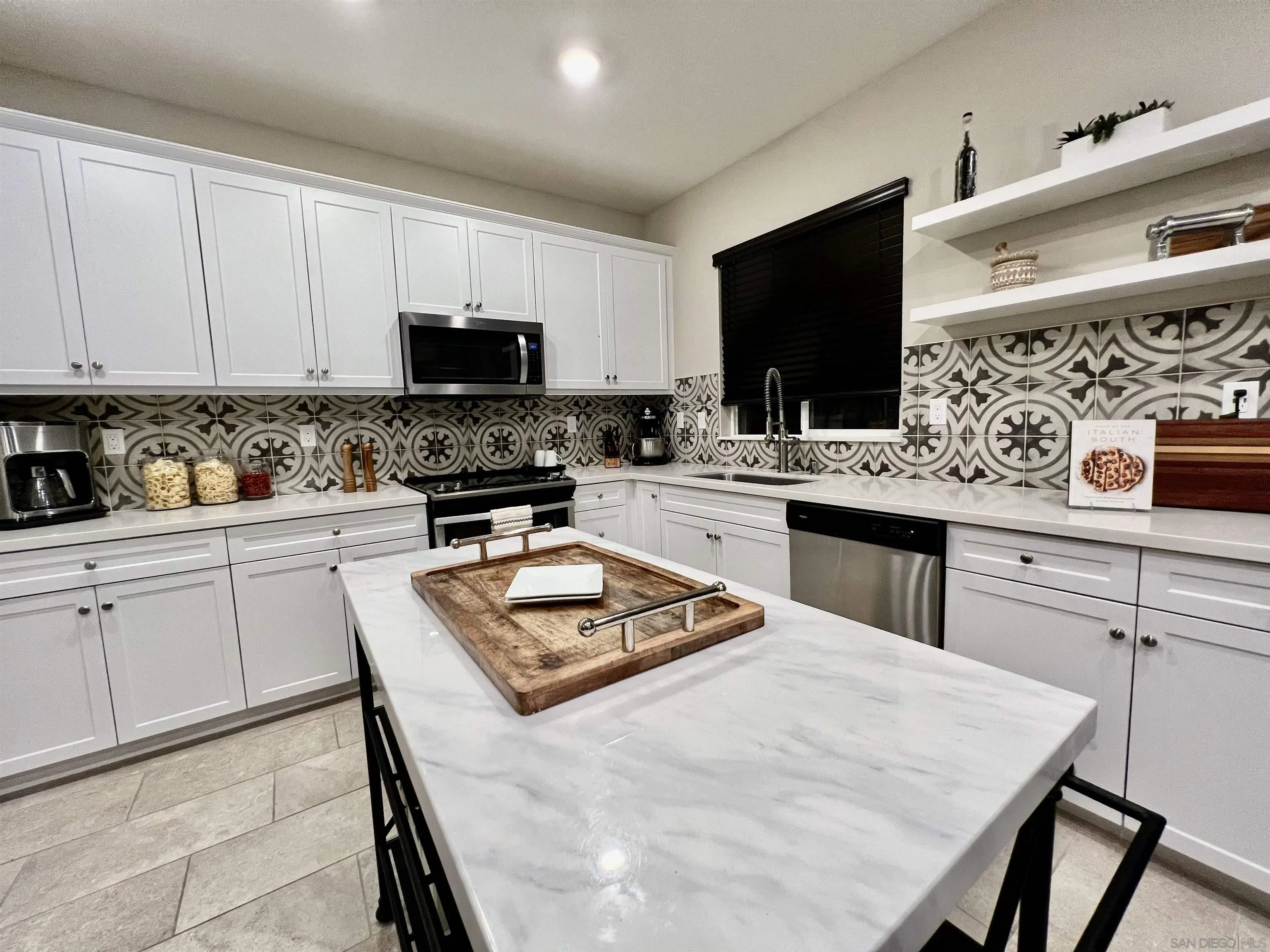 10660 Busch Street Spring Valley, CA 91978 - Photo 5 of 29 a kitchen with stainless steel appliances granite countertop a stove a sink a microwave a refrigerator and cabinets