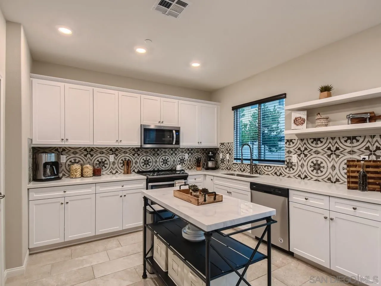 10660 Busch Street Spring Valley, CA 91978 - Photo 6 of 29 a kitchen with a sink a stove a refrigerator and cabinets