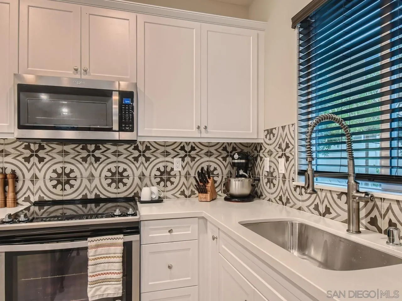 10660 Busch Street Spring Valley, CA 91978 - Photo 7 of 29 a kitchen with a sink cabinets and a stove top oven