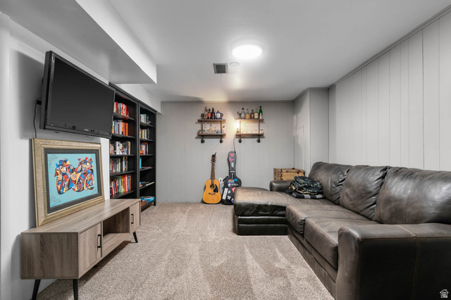 9902 South Poppy Lane Sandy, UT 84094 - Photo 16 of 25 Carpeted recreation room featuring white paneling, built-in shelving, and recessed lighting