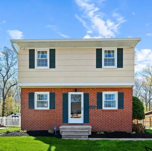 945 Homberg Avenue Baltimore, MD 21221 - Photo 1 of 27 a front view of a house with a yard and trees