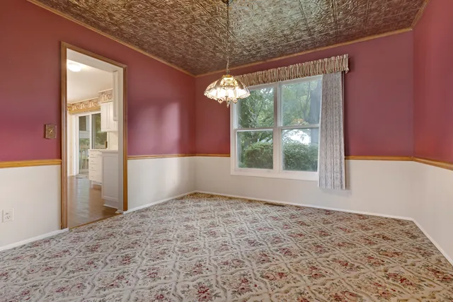 a view of a big room with windows and chandelier