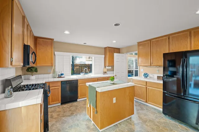 a kitchen with cabinets and stainless steel appliances