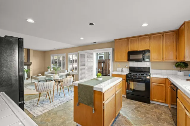 a kitchen that has a lot of cabinets in it and stainless steel appliances