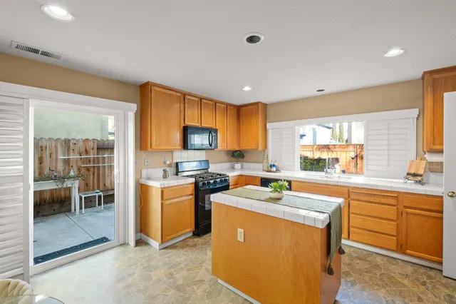 a kitchen with stainless steel appliances a stove sink and microwave