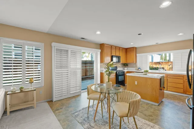 a kitchen with kitchen island wooden cabinets and counter space