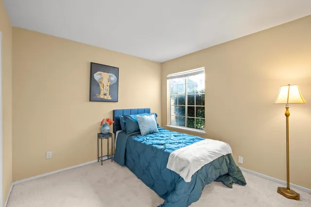 a bedroom with a bed and a lamp with window