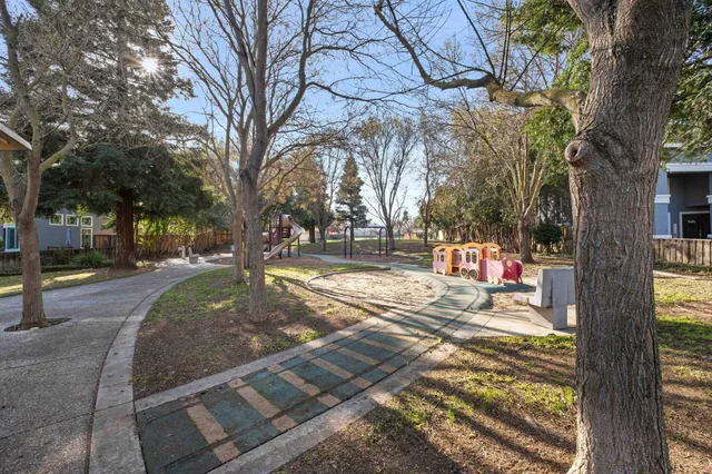a view of a house with a yard and sitting area