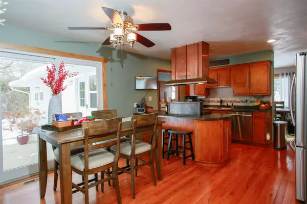 a dining table chairs and a kitchen view