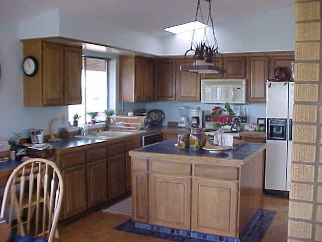 100 Coombs Road Moxee, WA 98936 - Photo 4 of 9 a kitchen with kitchen island granite countertop a sink stainless steel appliances and cabinets