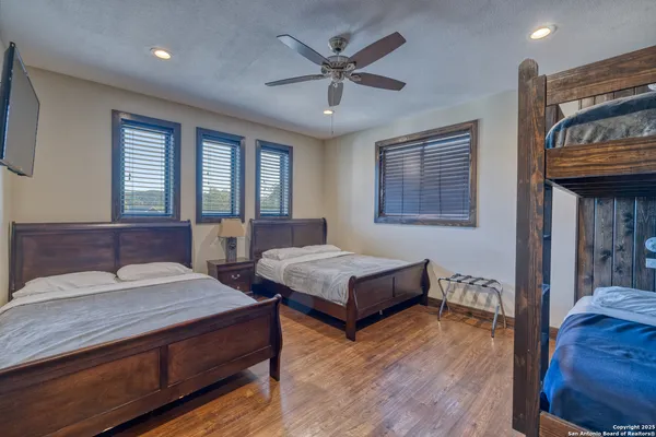 a bedroom with two beds and a chandelier