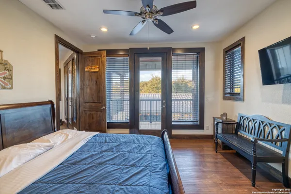 a bedroom with a large bed and a chandelier