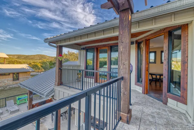 a view of a balcony and chairs next to a yard