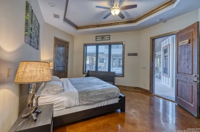 a bedroom with a bed mirror and window