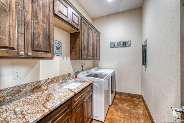 a bathroom with a granite countertop sink a toilet and mirror