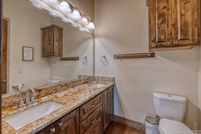 a spacious bedroom with two beds and a chandelier