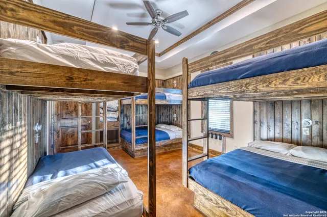 a view of a bedroom with furniture and balcony