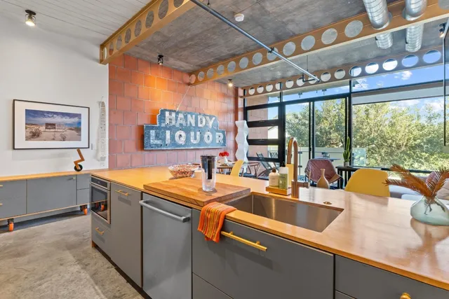 a room with pool table and windows