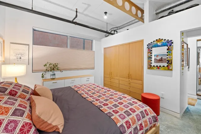 a bedroom with a bed and cabinets