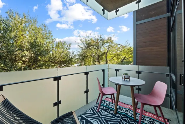 a view of a chairs and table in the balcony