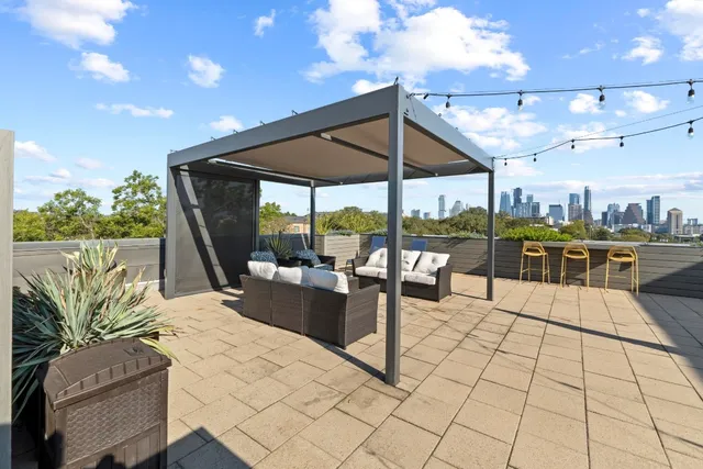 a view of a patio with dining table and chairs
