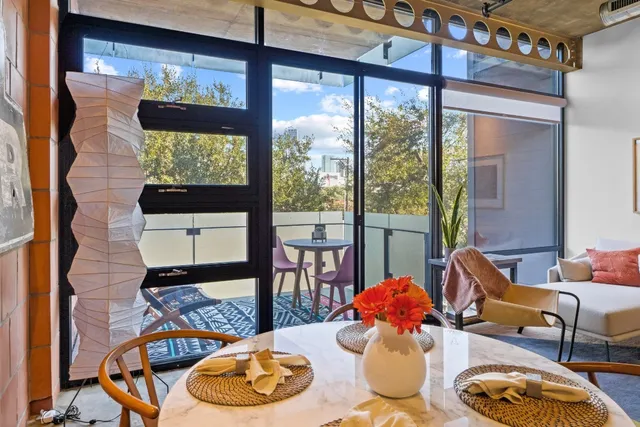 a dining room with furniture a rug and a large window