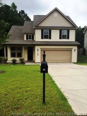 81 River Oak Street Spring Lake, NC 28390 - Photo 1 of 15 a front view of a house with garden