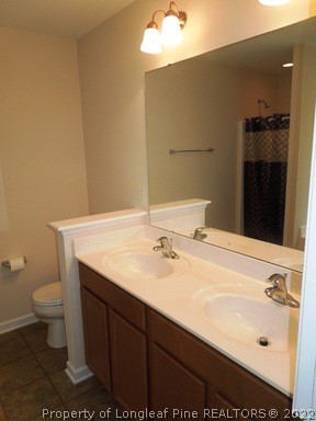 81 River Oak Street Spring Lake, NC 28390 - Photo 13 of 15 a bathroom with a sink and a toilet