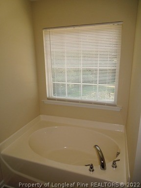 81 River Oak Street Spring Lake, NC 28390 - Photo 14 of 15 a bath tub sitting next to a window
