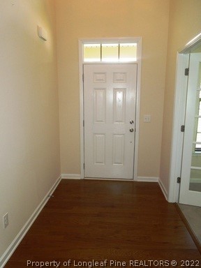 81 River Oak Street Spring Lake, NC 28390 - Photo 2 of 15 an empty room with wooden floor and windows