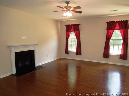 81 River Oak Street Spring Lake, NC 28390 - Photo 3 of 15 an empty room with wooden floor fan and windows