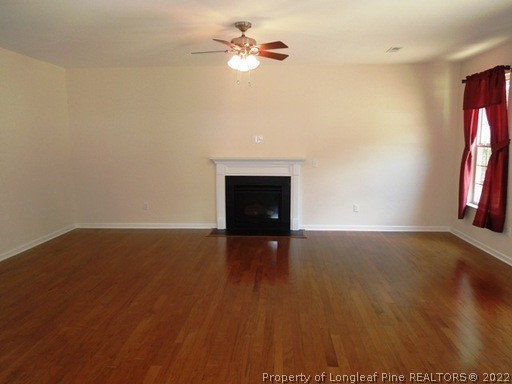 81 River Oak Street Spring Lake, NC 28390 - Photo 4 of 15 wooden floor in an empty room with a window