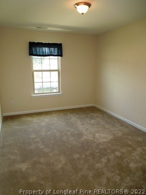 81 River Oak Street Spring Lake, NC 28390 - Photo 8 of 15 an empty room with a window