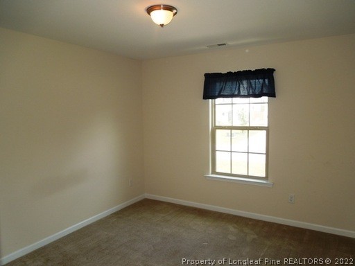 81 River Oak Street Spring Lake, NC 28390 - Photo 9 of 15 an empty room with a window