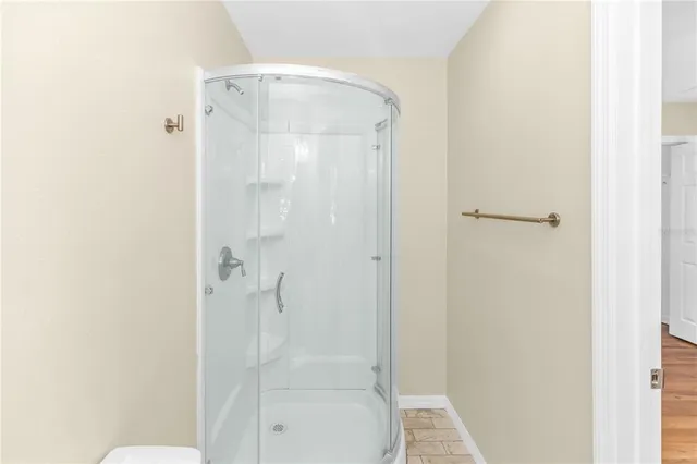a bathroom with a glass shower door