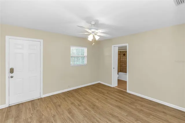 wooden floor in an empty room with a window