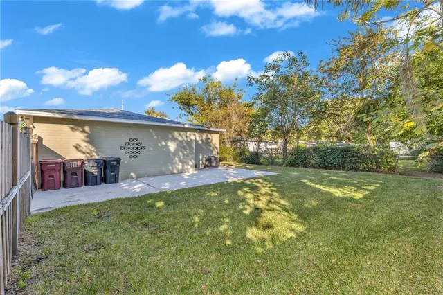 a view of a patio with table and chairs and potted plants