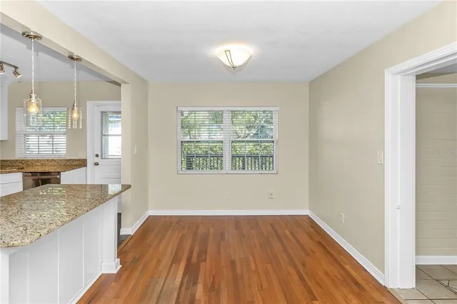a view of kitchen and hall with wooden floor