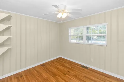 a view of a room with wooden floor and bathroom view
