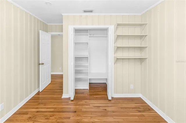 a view of a room with wooden floor and entryway