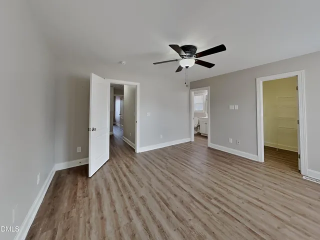 a view of empty room with wooden floor