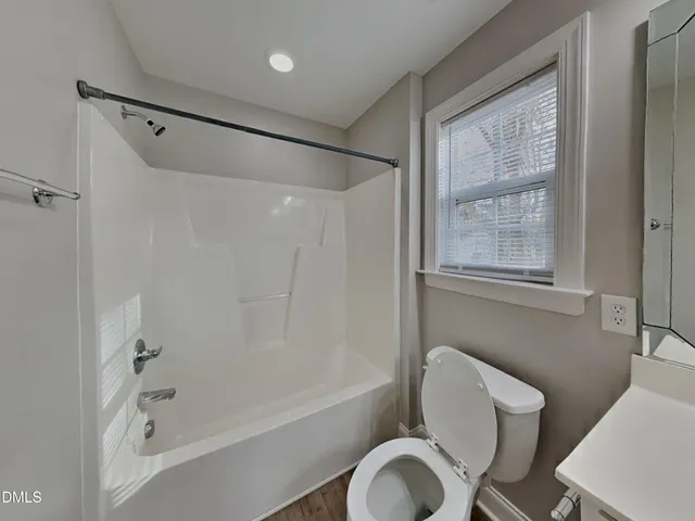 a bathroom with a toilet bathtub and shower