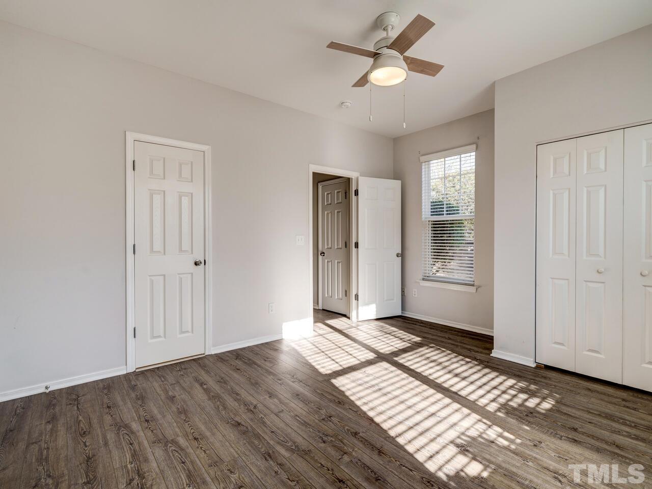 8219 Beaded Stone Street Raleigh, NC 27613 - Photo 18 of 45 wooden floor in an empty room with a window