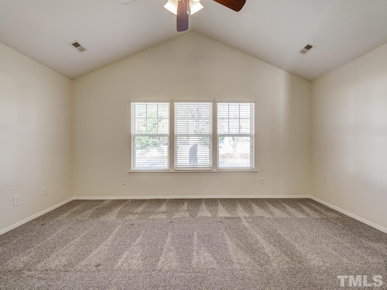 8219 Beaded Stone Street Raleigh, NC 27613 - Photo 21 of 45 wooden floor in an empty room with a window