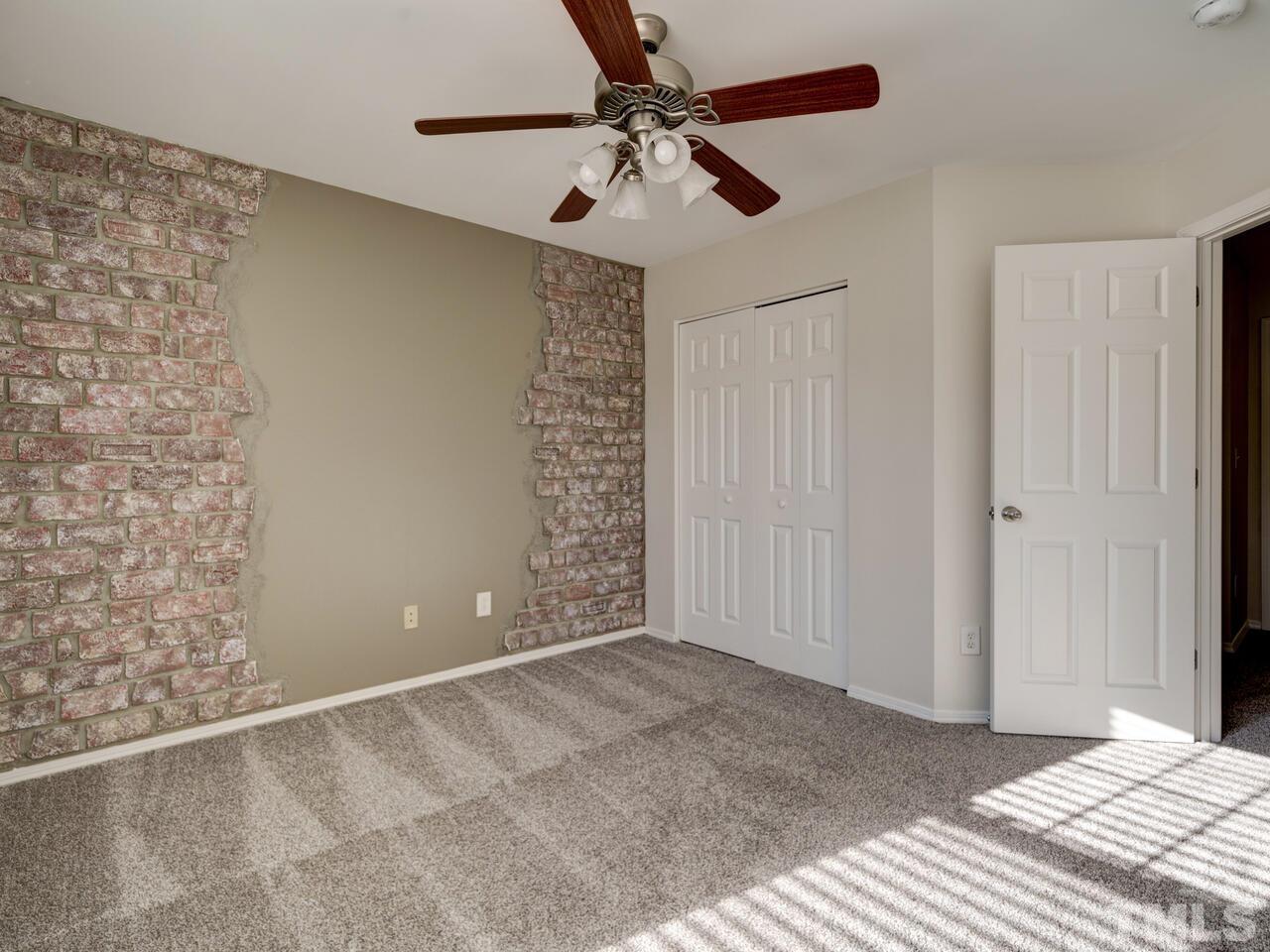8219 Beaded Stone Street Raleigh, NC 27613 - Photo 34 of 45 a view of an empty room with a ceiling fan
