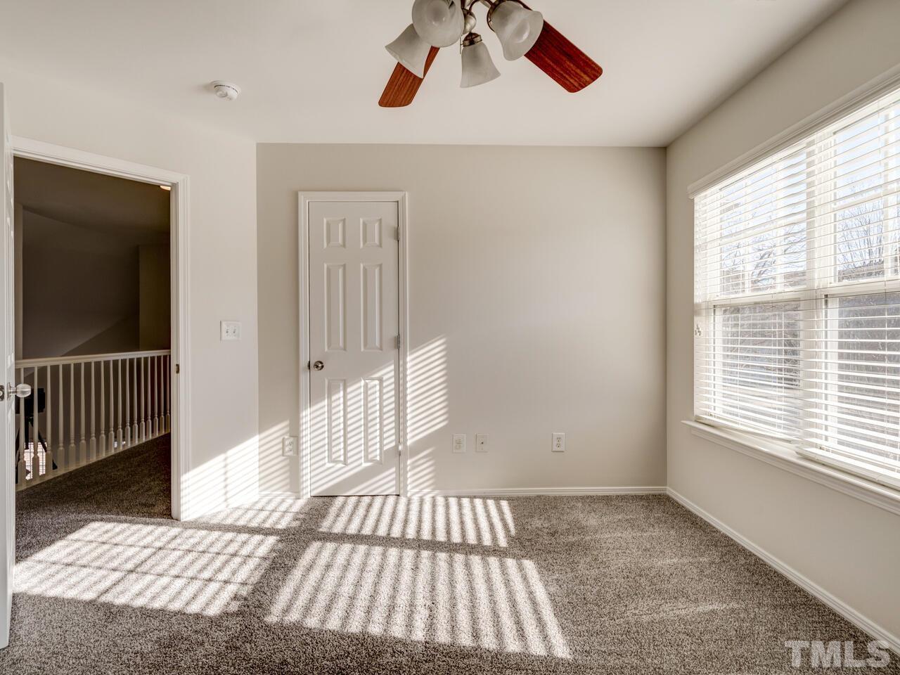 8219 Beaded Stone Street Raleigh, NC 27613 - Photo 36 of 45 a view of a livingroom with wooden floor and windows