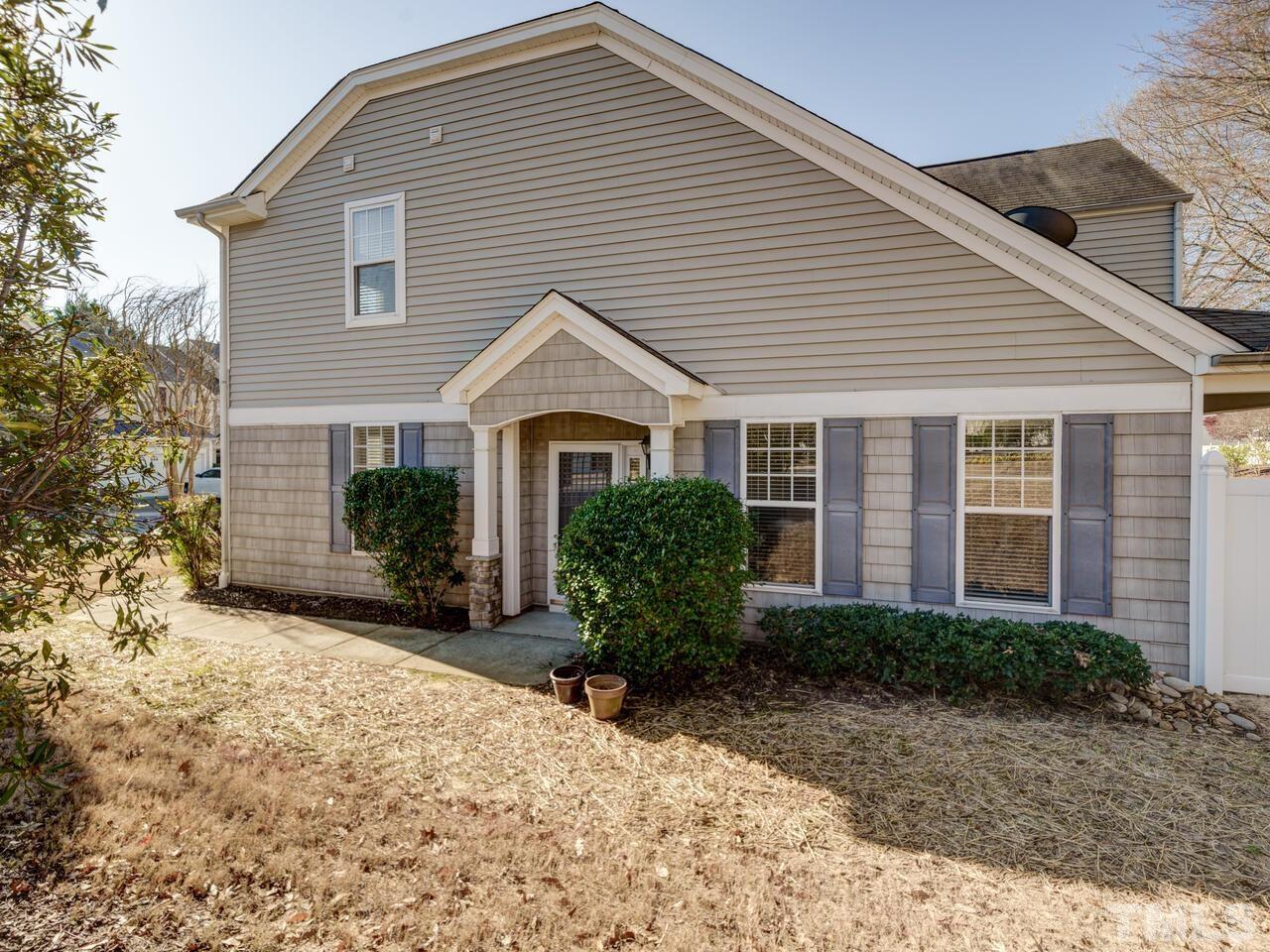8219 Beaded Stone Street Raleigh, NC 27613 - Photo 39 of 45 a front view of a house with garden
