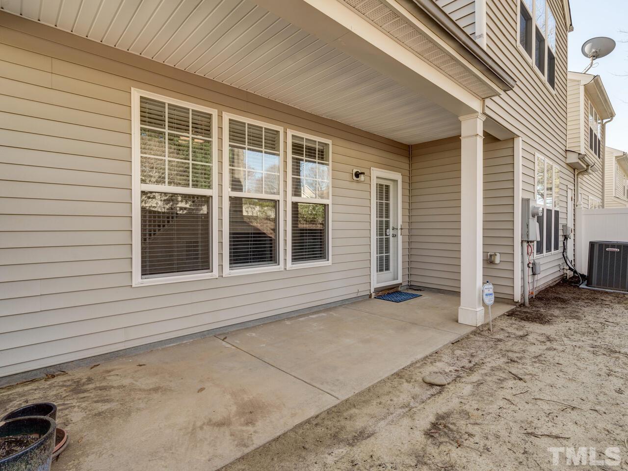 8219 Beaded Stone Street Raleigh, NC 27613 - Photo 41 of 45 a view of a house with a door and wooden fence