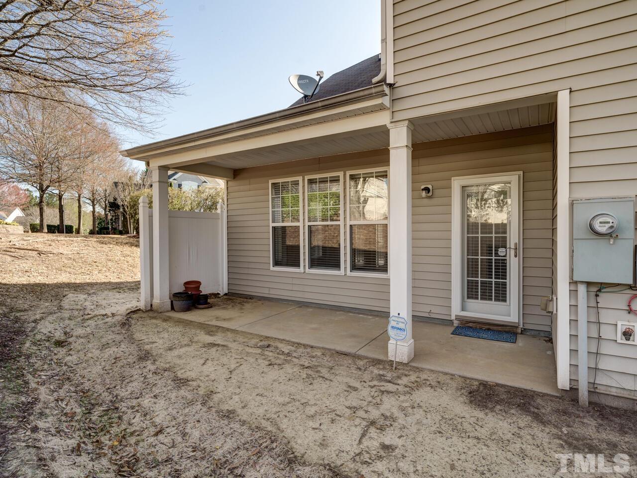 8219 Beaded Stone Street Raleigh, NC 27613 - Photo 42 of 45 a view of a house with a door and wooden roof
