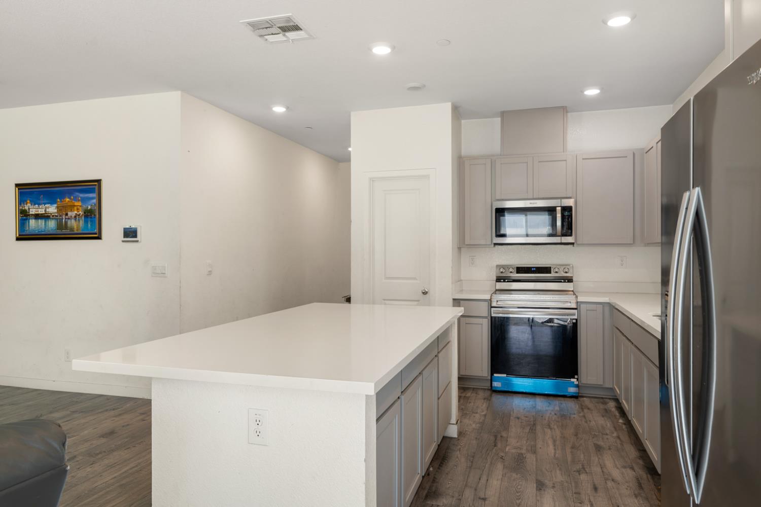 7664 Walpole Way Elk Grove, CA 95758 - Photo 13 of 43 a kitchen with stainless steel appliances a refrigerator sink and stove